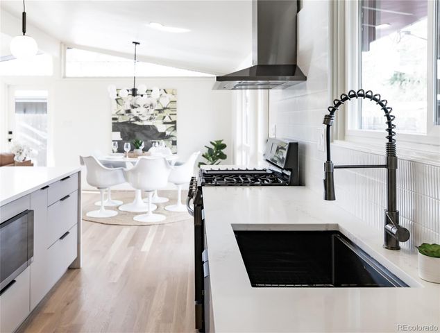 a kitchen with stainless steel appliances kitchen island granite countertop a sink and cabinets
