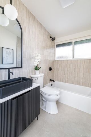a bathroom with a sink a toilet and bathtub