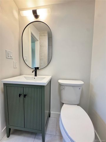 a bathroom with a toilet a sink and a mirror