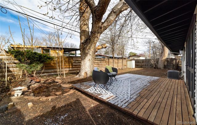 a view of backyard with a deck and wooden floor