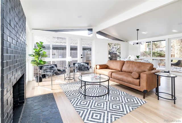 a living room with furniture a fireplace and a table