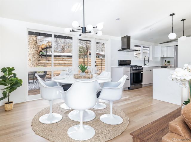 a large kitchen with furniture and a chandelier
