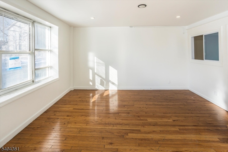 29 William Street Orange, NJ 07050 - Photo 4 of 10 a view of empty room with wooden floor and fan