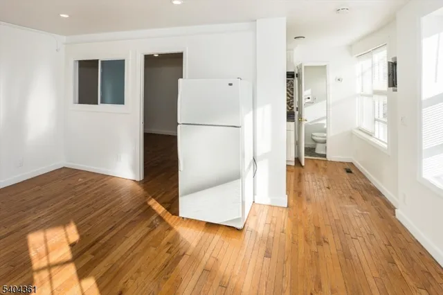 a view of front door and hallway with wooden floor
