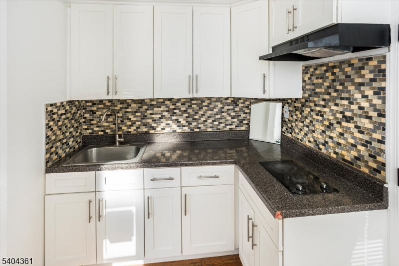 29 William Street Orange, NJ 07050 - Photo 6 of 10 a kitchen with a sink and cabinets