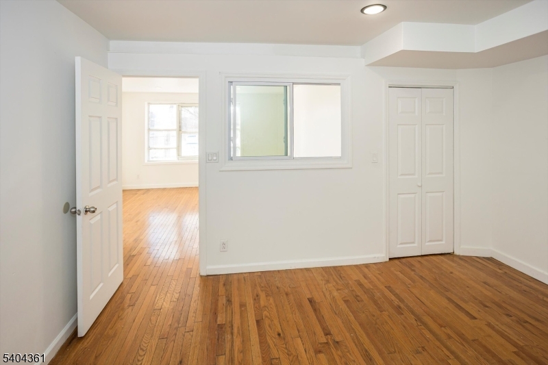 29 William Street Orange, NJ 07050 - Photo 9 of 10 an empty room with wooden floor and windows