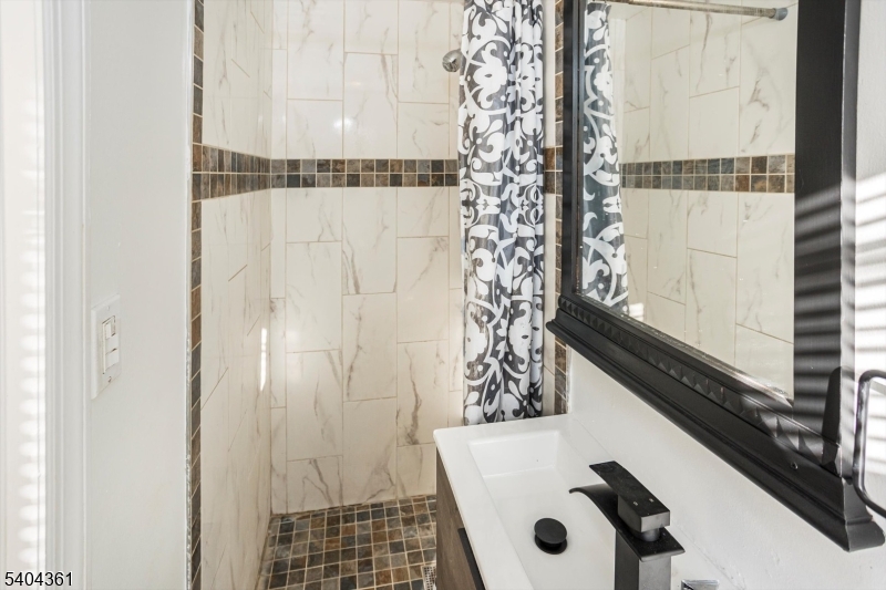 29 William Street Orange, NJ 07050 - Photo 10 of 10 a bathroom with a shower and a sink