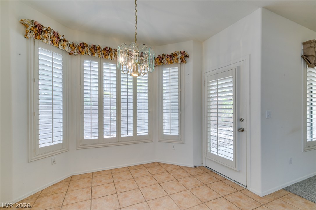 2189 Chapman Ranch Drive Henderson, NV 89012 - Photo 24 of 60 Tiled flooring and a classic bay window elevate this versatile dining alcove.