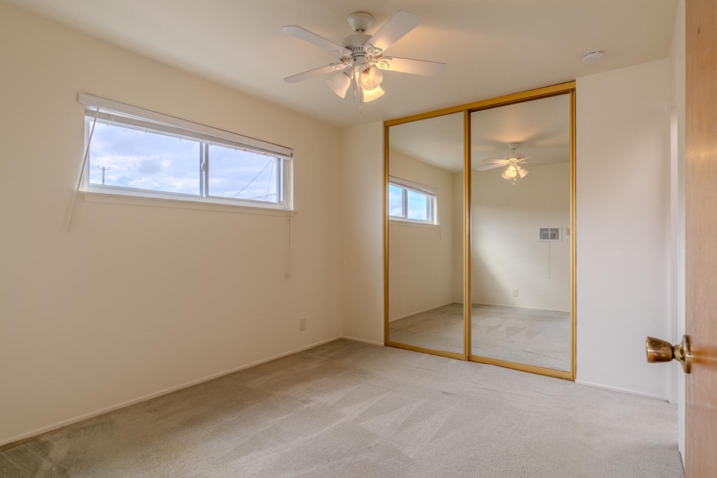 15 Santa Maria Avenue, Unit 3 Pacifica, CA 94044 - Photo 8 of 10 an empty room with fan and windows