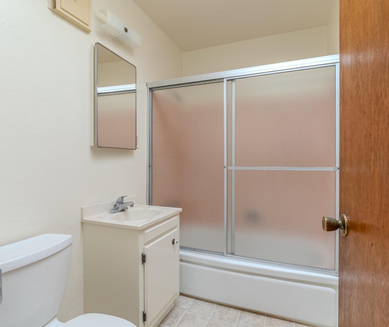 15 Santa Maria Avenue, Unit 3 Pacifica, CA 94044 - Photo 9 of 10 a bathroom with a sink mirror vanity and toilet