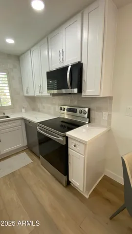 a kitchen with a stove and a sink