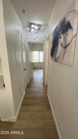 a view of a hallway with wooden floor