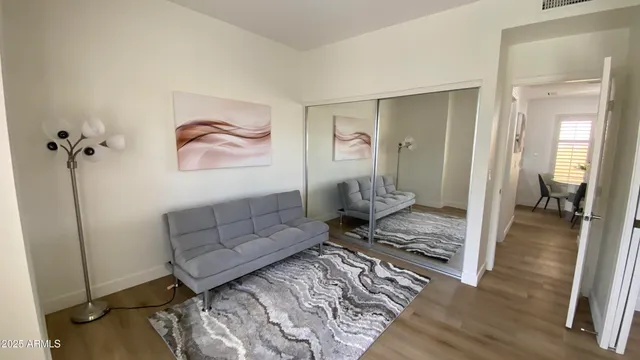 a living room with furniture and wooden floor