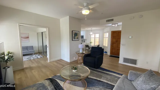 a living room with furniture and a chandelier