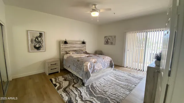 a bedroom with a bed and a view of kitchen