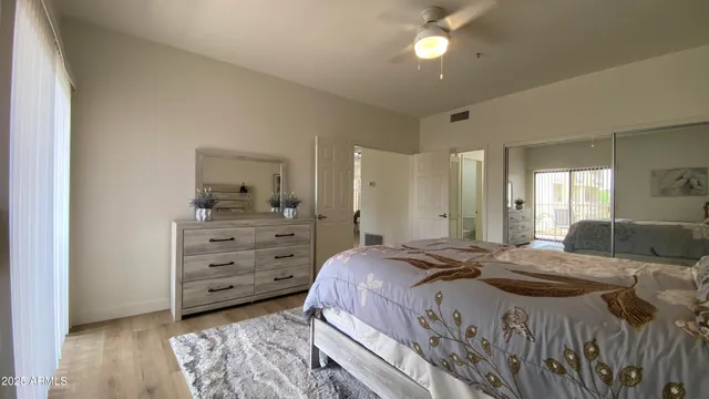a bedroom with a bed and a chandelier