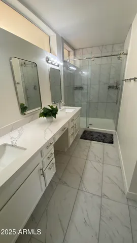 a bathroom with a sink a toilet and mirror