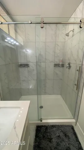 a bathroom with a bathtub and a shower