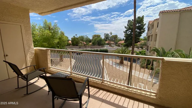 a view of a chairs and table in the balcony