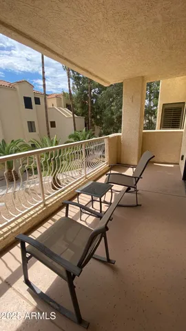 a view of a balcony with chairs