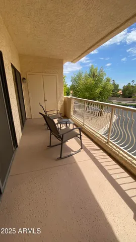 a view of a two chairs in the balcony