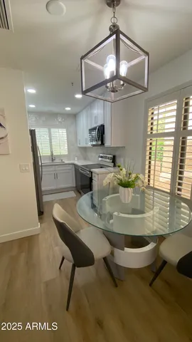 a kitchen with stainless steel appliances granite countertop a sink a stove and a refrigerator