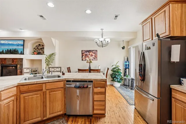 a kitchen with stainless steel appliances granite countertop a refrigerator sink and cabinets