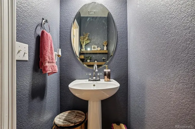 a bedroom with a bed a dresser next to a window