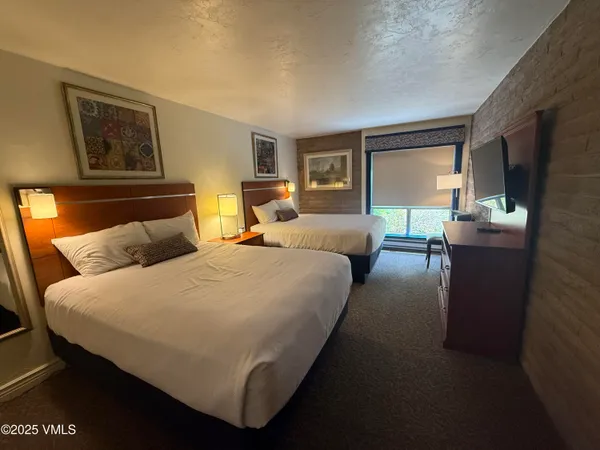 a bed room with a bed and a night stand