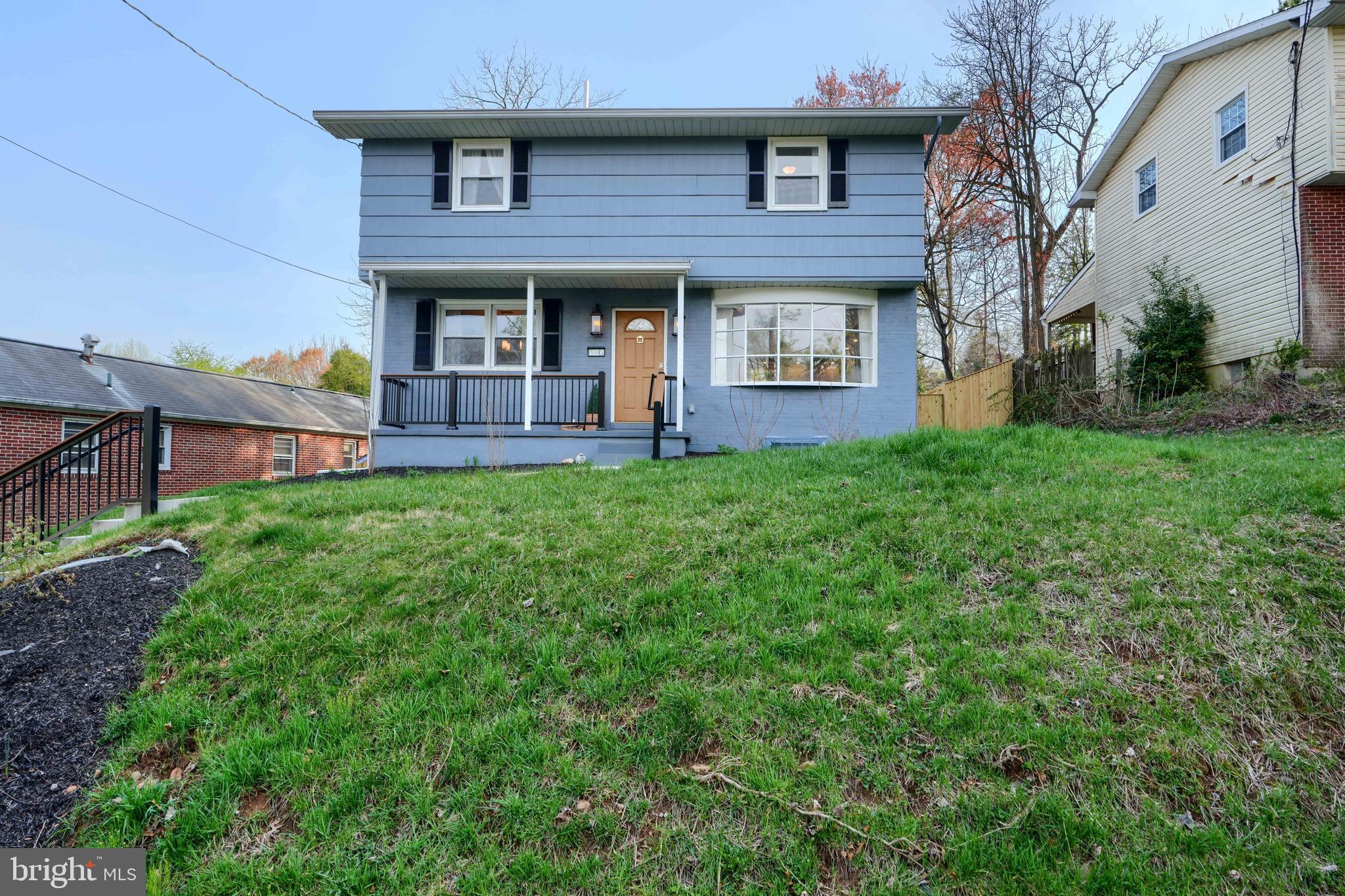 1103 Litchfield Road, Unit H Baltimore, MD 21239 - Photo 2 of 74 a view of a brick house with a yard potted plants and a table and chair