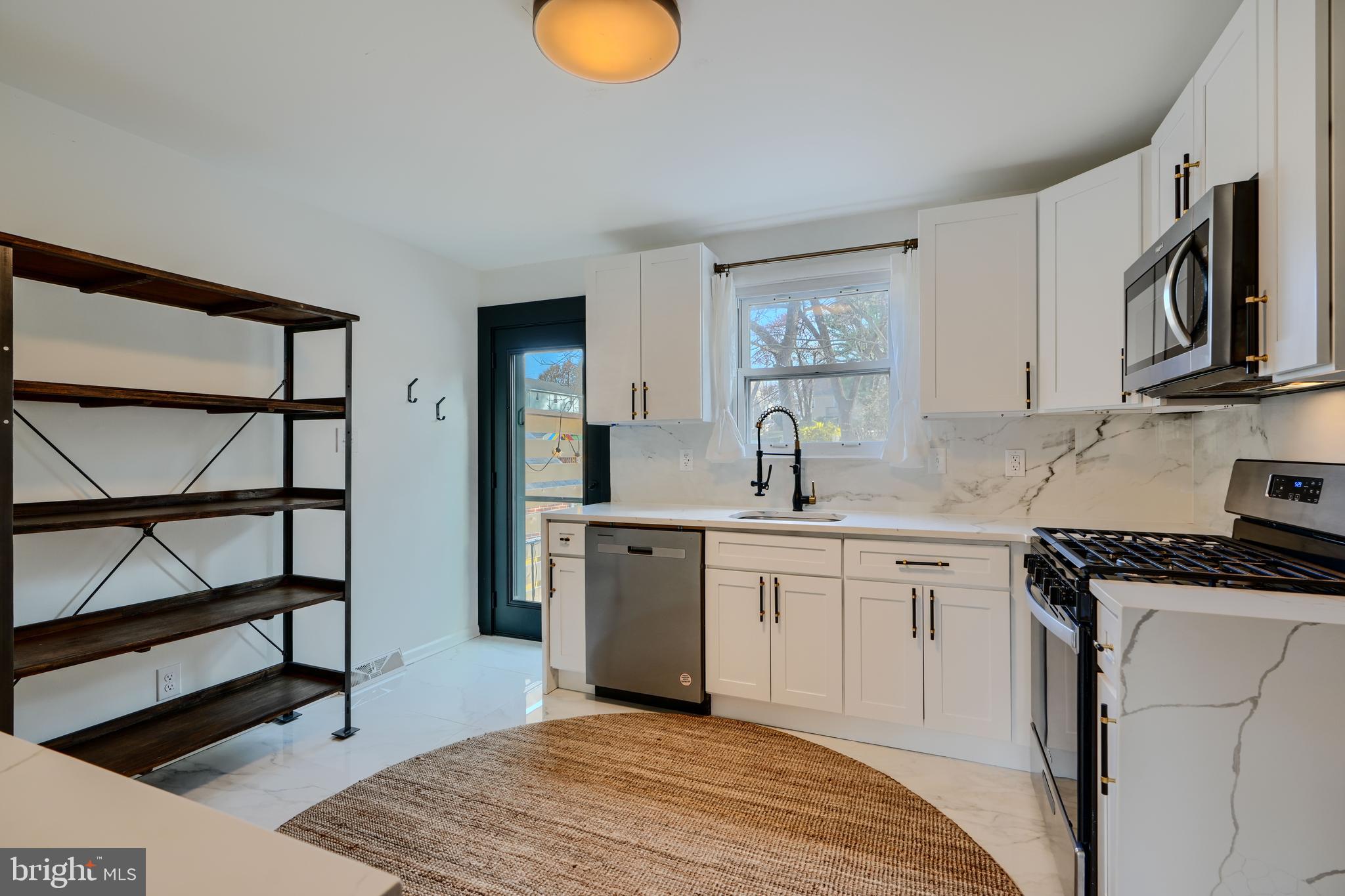 1103 Litchfield Road, Unit H Baltimore, MD 21239 - Photo 33 of 74 a kitchen with stainless steel appliances granite countertop a stove a sink and a microwave