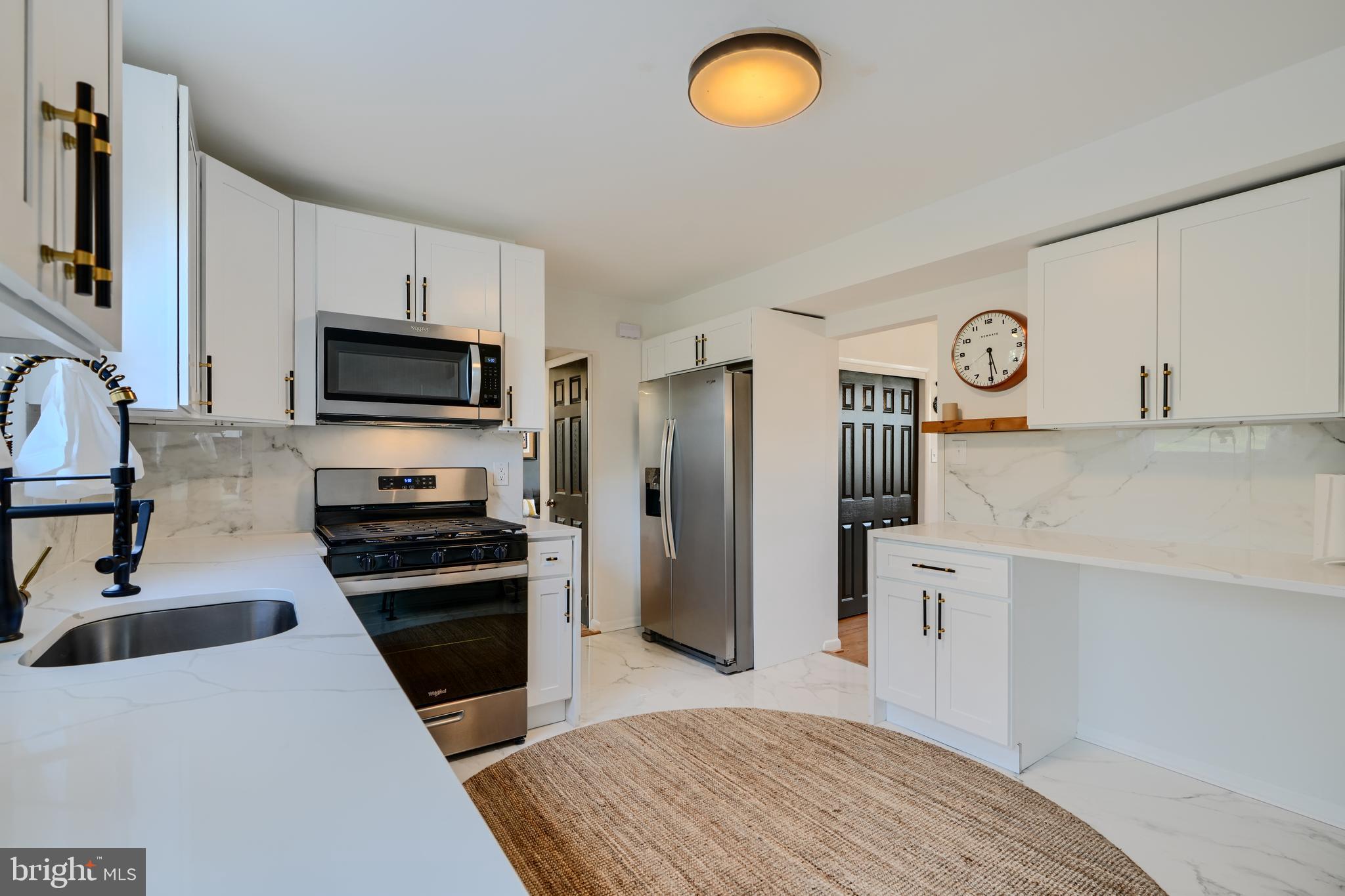 1103 Litchfield Road, Unit H Baltimore, MD 21239 - Photo 34 of 74 a kitchen with stainless steel appliances a refrigerator stove and sink