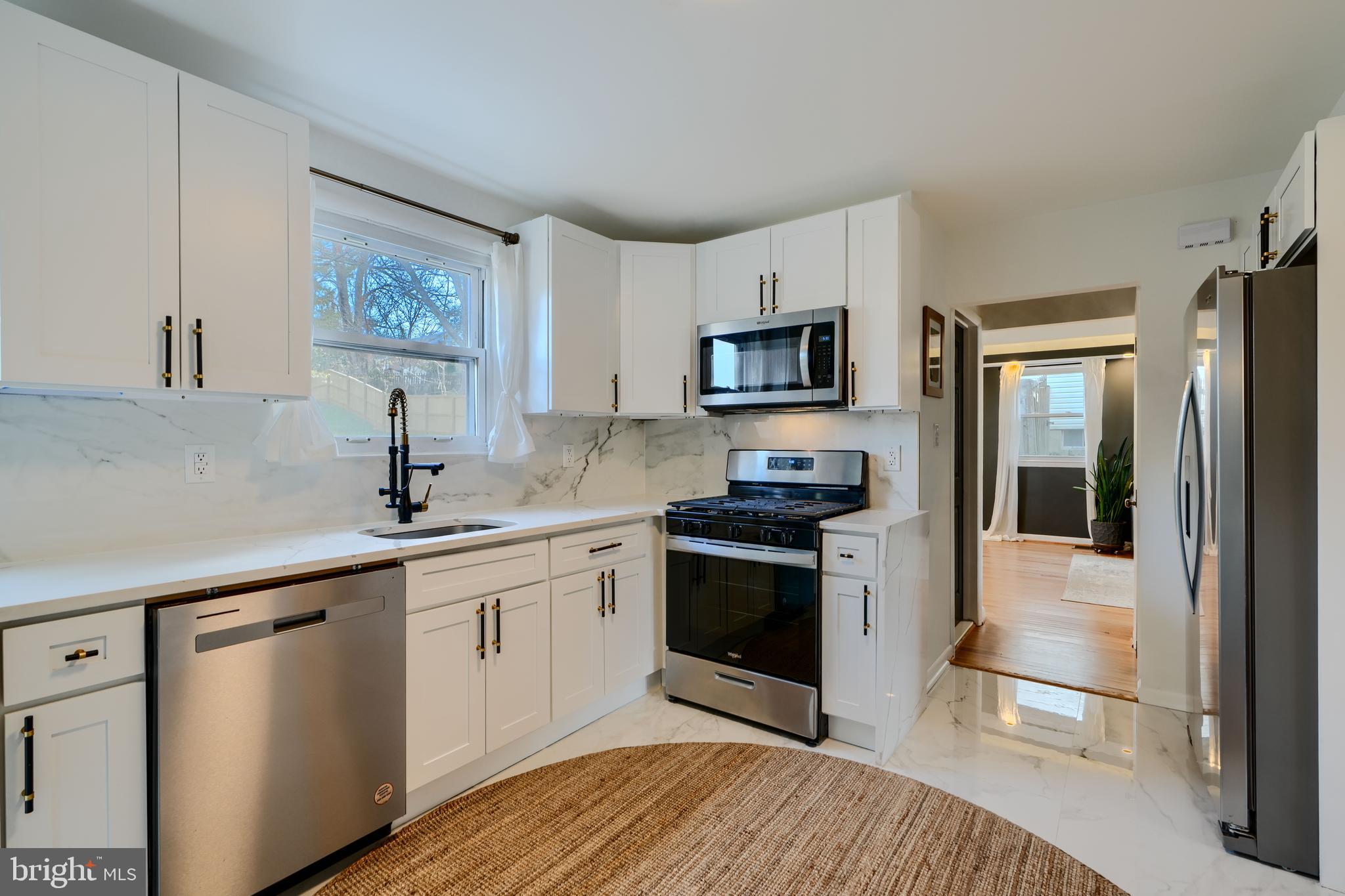 1103 Litchfield Road, Unit H Baltimore, MD 21239 - Photo 36 of 74 a kitchen with stainless steel appliances a stove sink and microwave