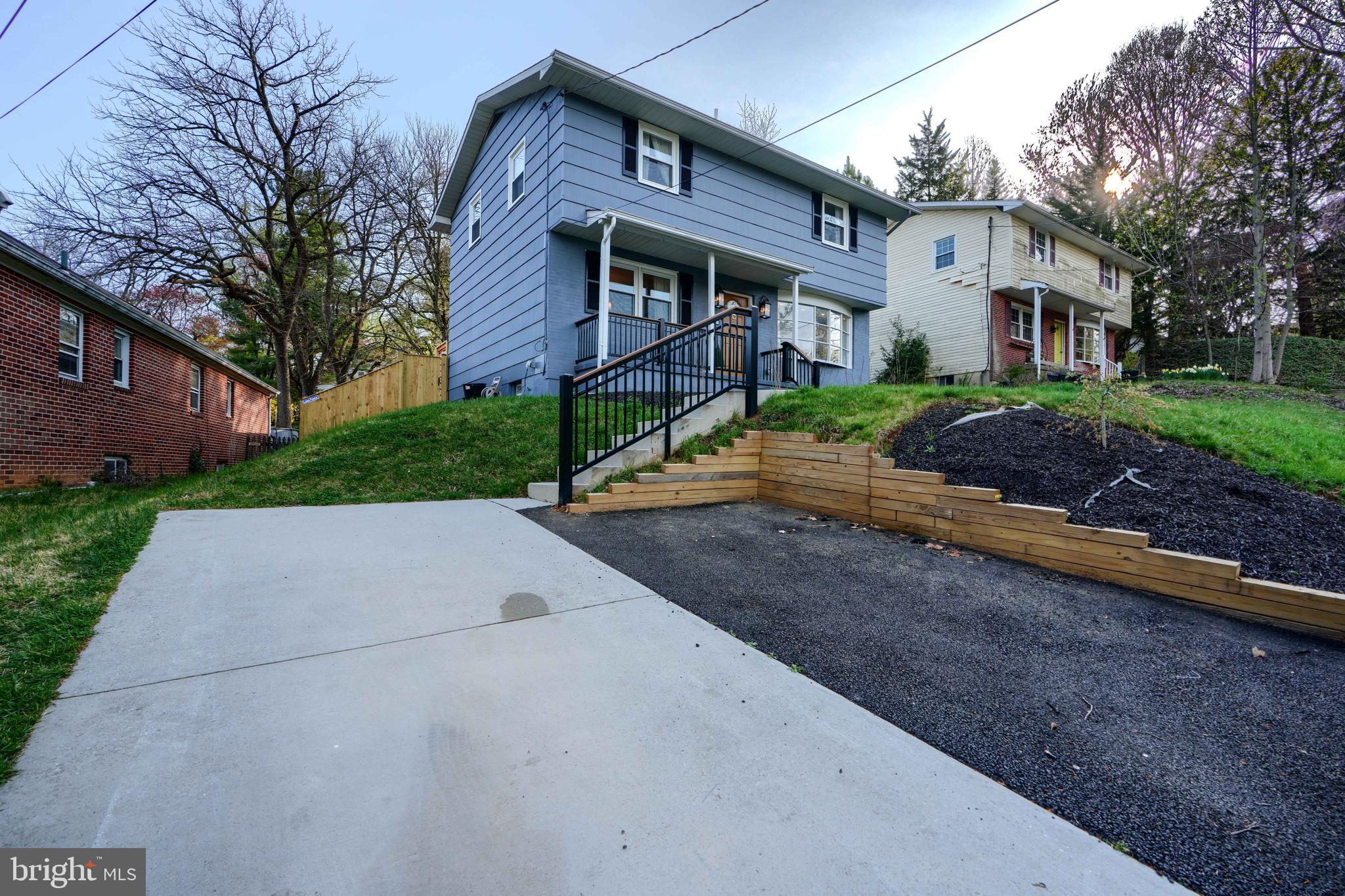 1103 Litchfield Road, Unit H Baltimore, MD 21239 - Photo 4 of 74 a front view of a house with a yard and garage