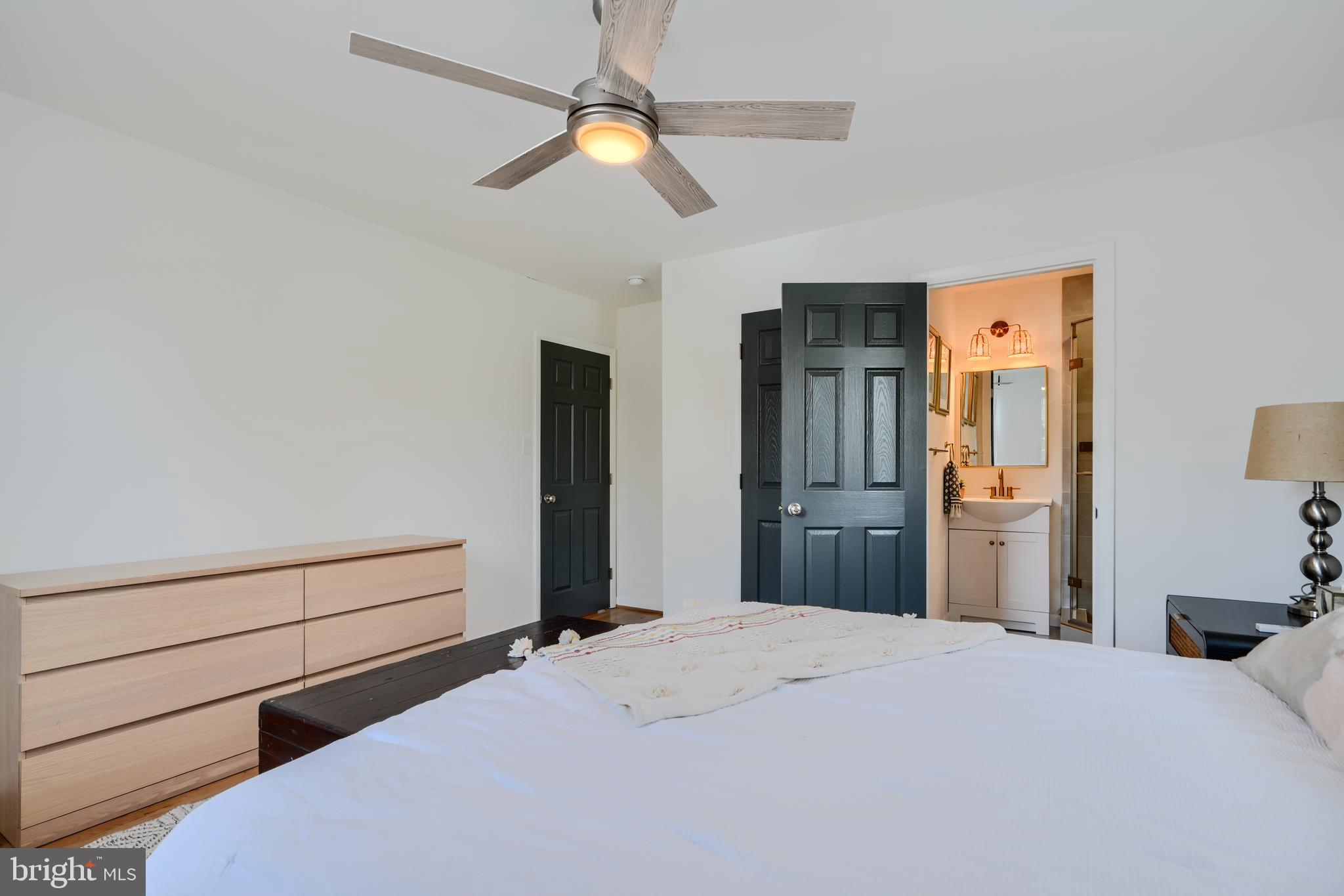 1103 Litchfield Road, Unit H Baltimore, MD 21239 - Photo 42 of 74 a bedroom with a bed and a chandelier