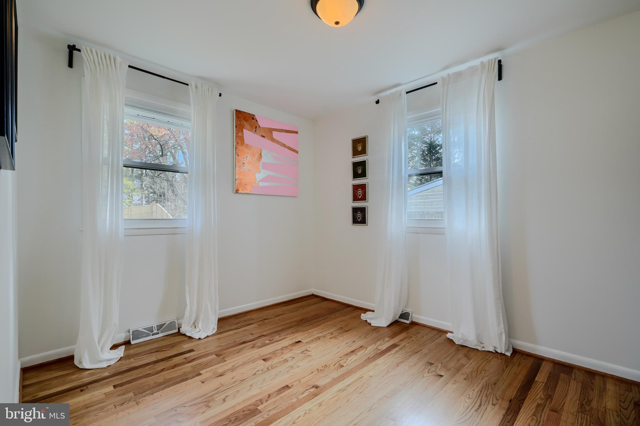 1103 Litchfield Road, Unit H Baltimore, MD 21239 - Photo 54 of 74 an empty room with wooden floor and window