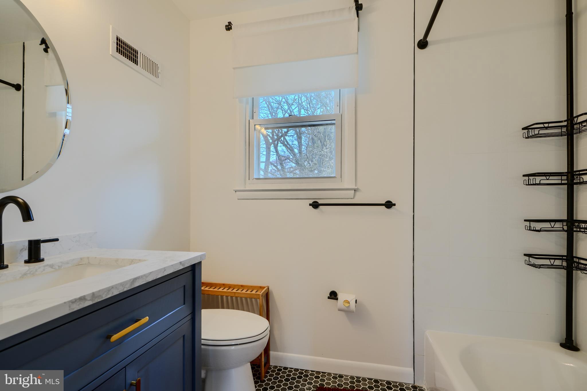 1103 Litchfield Road, Unit H Baltimore, MD 21239 - Photo 57 of 74 a bathroom with a granite countertop sink toilet and shower