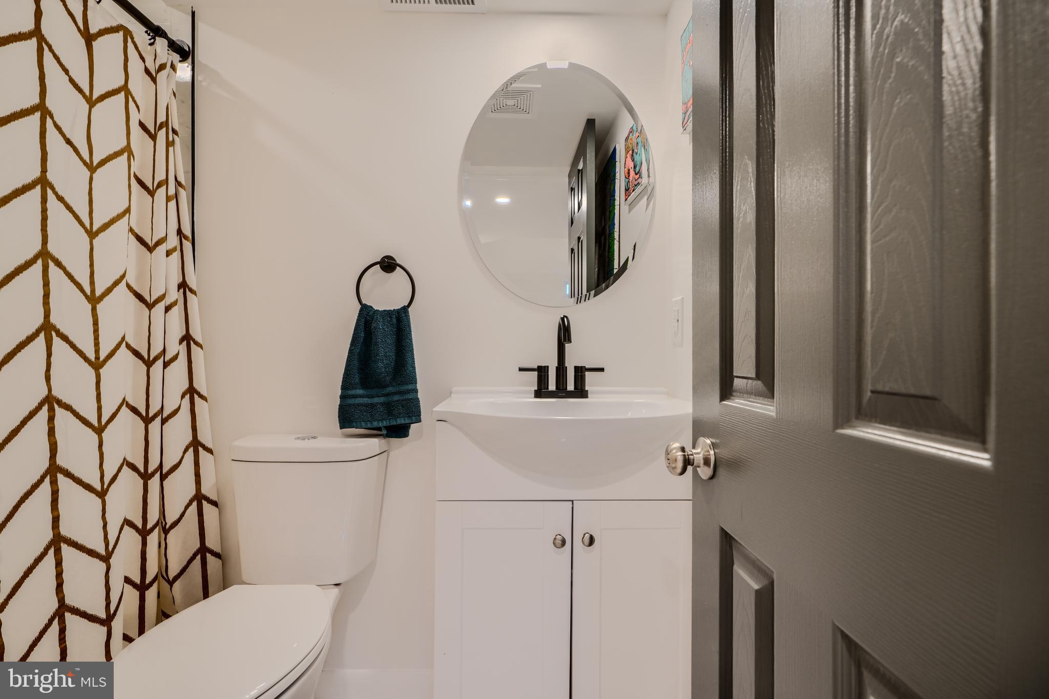 1103 Litchfield Road, Unit H Baltimore, MD 21239 - Photo 65 of 74 a bathroom with a toilet and a sink