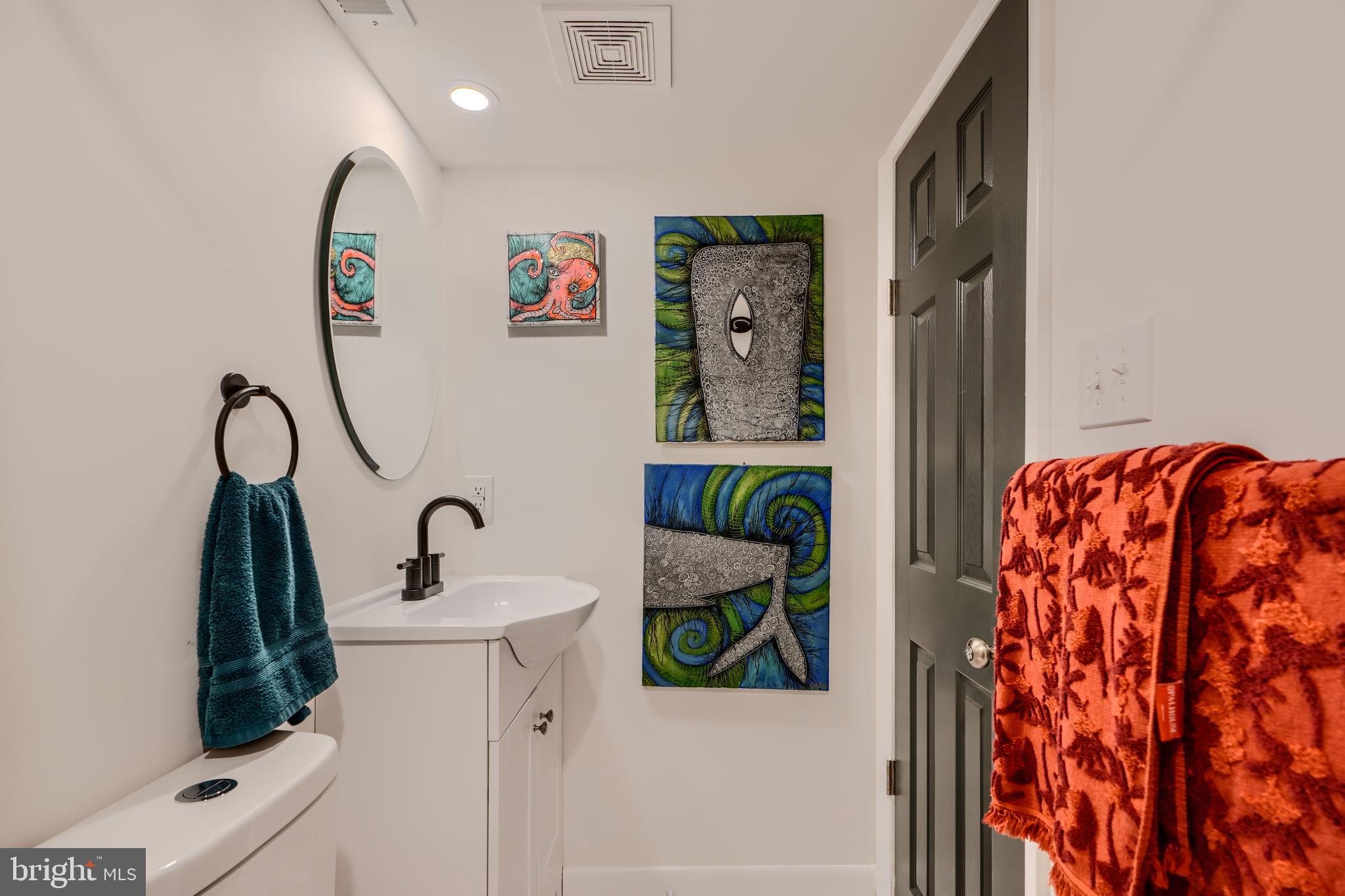 1103 Litchfield Road, Unit H Baltimore, MD 21239 - Photo 69 of 74 a bathroom with a sink and a mirror