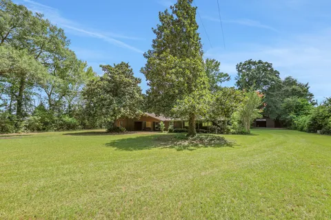 a backyard of a house with a lots of trees