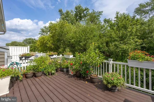 a view of balcony with wooden floor and fence