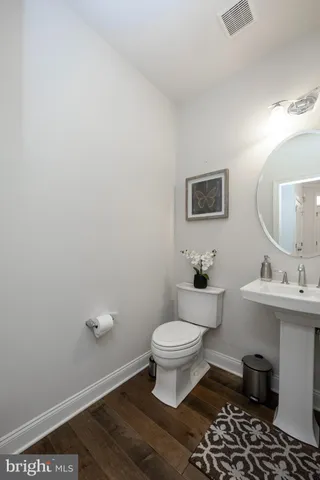 a bathroom with a sink toilet and a mirror