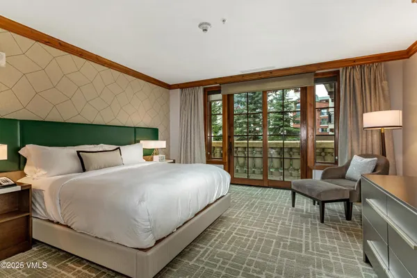 a bedroom with a large bed and a large window