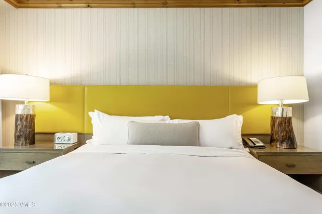 a bedroom with a bed and a lamp