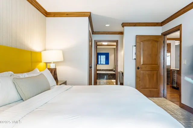 a bedroom with a bed and a lamp