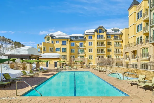 a swimming pool view with a outdoor seating