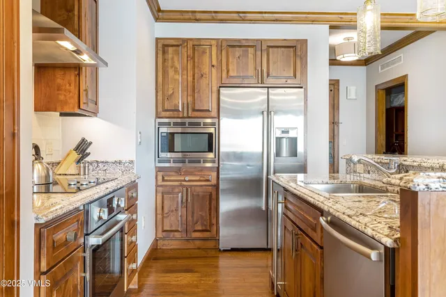a kitchen with stainless steel appliances granite countertop a refrigerator and a sink