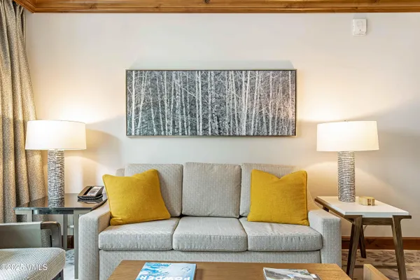 a living room with a couch and a lamp on table