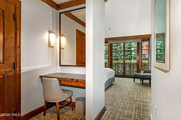 a view of a bedroom with furniture and a window