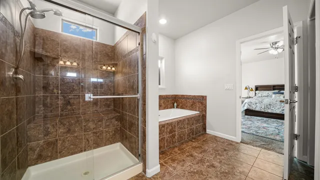 a bathroom with a tub and shower